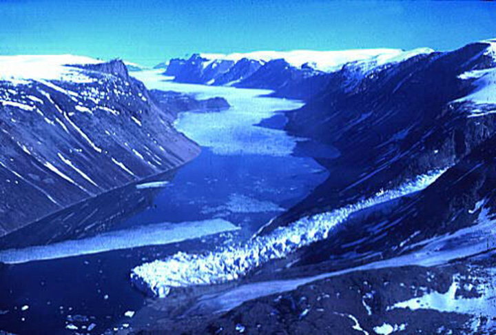 Figure 5: Baffin Island, Nunavut - This photograph shows a valley where a glacier is flowing off an ice cap into a river located at the bottom of this valley. The ice cap is located at the top of a plateau on the right side of the photograph.
